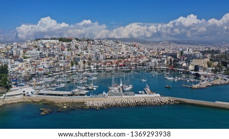 Aerial drone bird's eye view panoramic photo of iconic round shaped picturesque port of Mikrolimano with sail boats and yachts docked and beautiful clouds, Piraeus port, Attica, Greece