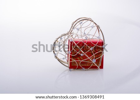 The Holy Quran in mini size in a heart shaped cage