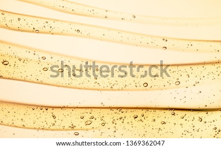 Cream gel yellow orange retinol transparent cosmetic sample texture with bubbles isolated on white background Royalty-Free Stock Photo #1369362047