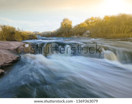 rushing river at the sunset