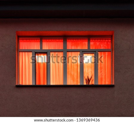 orange light inside window at night Royalty-Free Stock Photo #1369369436