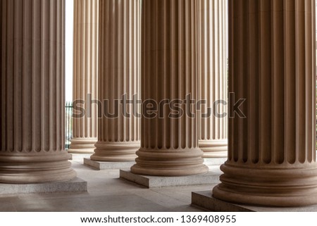 Court house or museum pillars or columns monotone in color and soft ambience Royalty-Free Stock Photo #1369408955