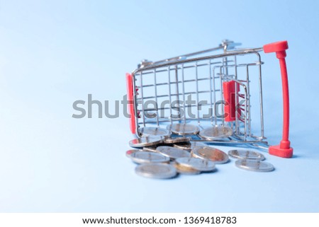 Small cart Trading concept And coins that are stacked