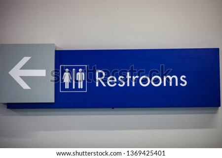 Toilet icons set. Men and women WC signs for restroom.Blue restroom sign on a  wall