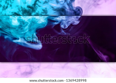 Abstract art colored pink and blue  smoke on black and white isolated background. Stop the movement of multicolored smoke on dark background
