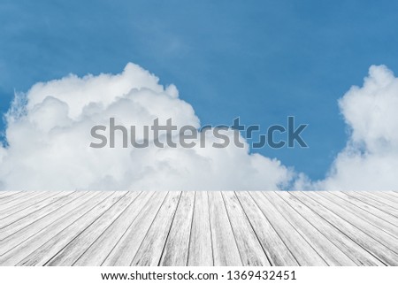 Cloudscape of natural sky with blue sky and white clouds in the sky use for wallpaper background with wood table or terrace