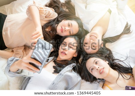 Smiling fashion women friend meeting talking together on bed above view
