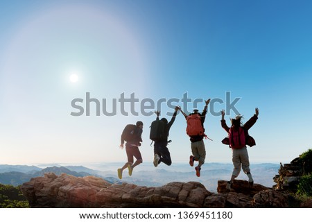 Group of happy hiker jumping on the hill. hiking holiday, wild adventure