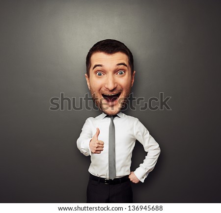 happy businessman with big head showing thumbs up. funny picture over dark background