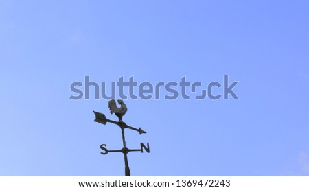 Blue sky weathercock