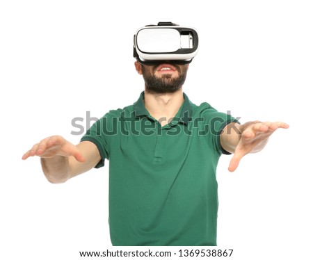 Emotional young man playing video games with virtual reality headset isolated on white