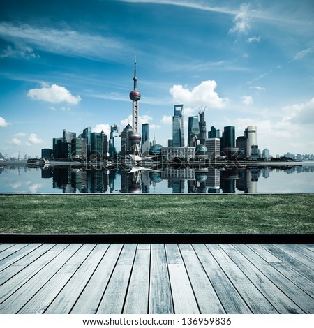 shanghai skyline with reflection and wooden floor and lawn