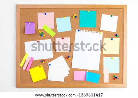 Cork board with several colorful blank notes with pins Royalty-Free Stock Photo #1369601417
