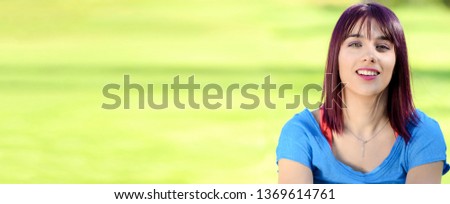 portrait of a beautiful young woman with a blue shirt, outdoors, horizontal photo banner