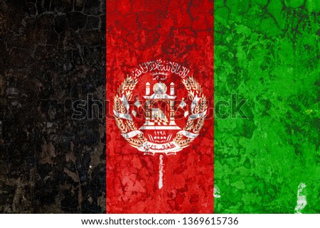 National flag of Afghanistan on the background of the old wall covered with peeling paint. Concept of country, nation and patriotism symbol