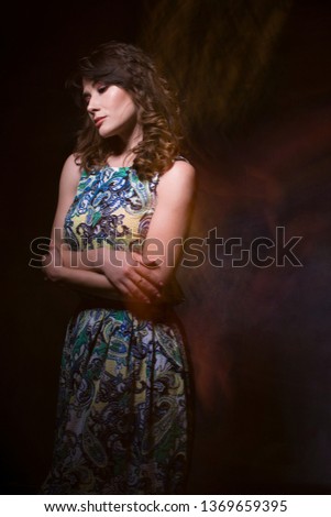 Beautiful girl on a dark background with her phantoms. mystical photo.