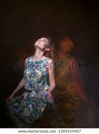 Beautiful girl on a dark background with her phantoms. mystical photo.