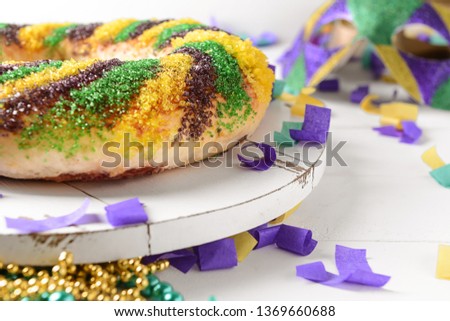 Festive cake for Mardi Gras (Fat Tuesday) holiday on white table