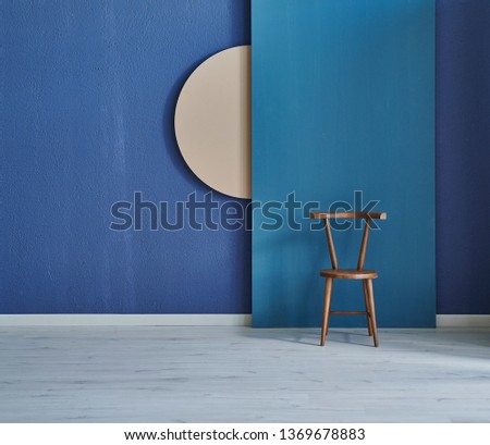 Decorative blue background, wooden chair and round texture wall.