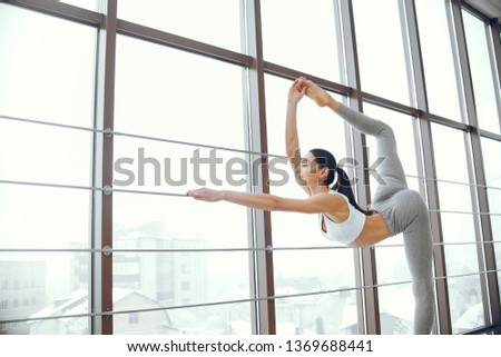 Beautiful girl training. Woman make exercise in a gym