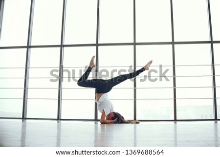 Beautiful girls in a yoga studio. Woman make exercise in a gym