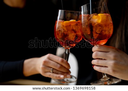 Friends toasting with aperol spritz cocktails Royalty-Free Stock Photo #1369698158