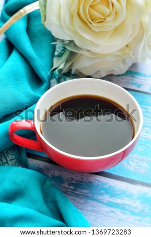 Close up of a cup of coffee on wooden table.