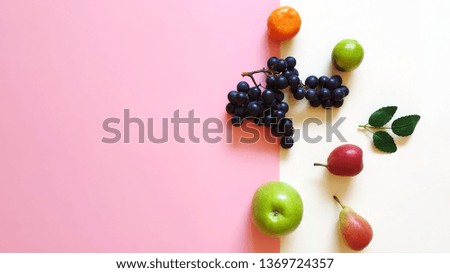 
Fresh Eco Fruits Assortment  vitamines orange apelsin lilac grape yellow  pear mandarin and green apple blue plate healthy fitness food diet  pink modern abstract concept background 