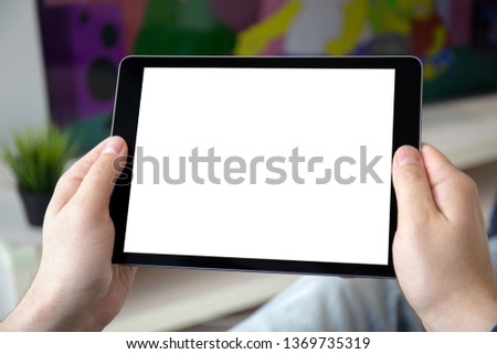 man hands holding computer tablet with isolated screen in the home room