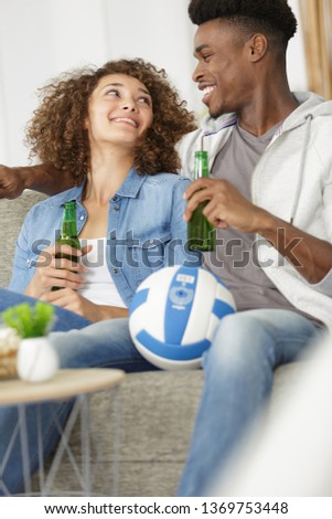 picture of couple talking holding beer bottle