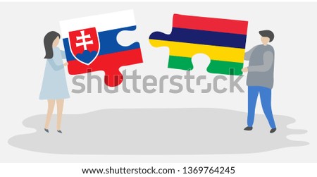 Couple holding two puzzles pieces with Slovak and Mauritian flags. Slovakia and Mauritius national symbols together.