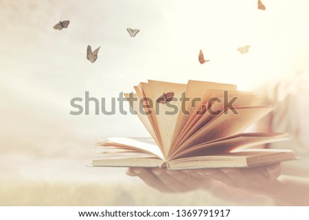 surreal moment of freedom for butterflies coming out of an open book Royalty-Free Stock Photo #1369791917