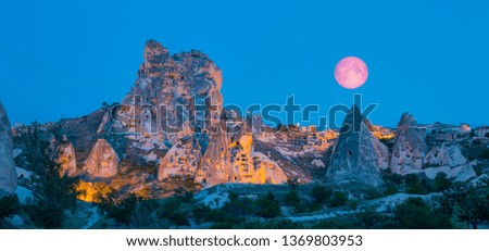 Natural stone fortress in Uchisar with full moon at dusk "Elements of this image furnished by NASA "