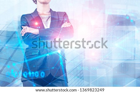 Unrecognizable confident businesswoman with crossed arms standing over skyscraper background with double exposure of digital technology interface. Concept of hi tech. Toned image