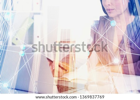 Businesswoman typing on laptop in office with double exposure of cityscape and immersive network interface. Concept of hi tech and modern technology. Toned image