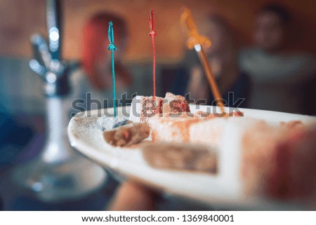 persimmon, oriental sweets on a plate in a restaurant, Arabian interior. eastern tea ceremony. Selective focus, Hookah bar, rest concept