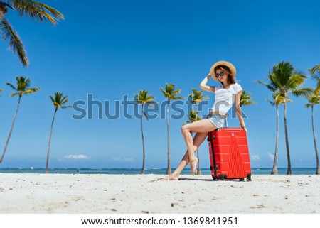 Pretty woman beach hat red suitcase white sand island beach vacation