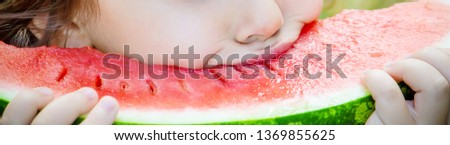 A child eats watermelon. Selective focus. Food nature