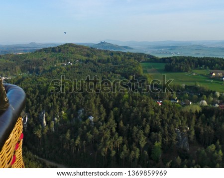 View from a hot air balloon towards castle ruins called Trosky and rock town called Prachovske skaly in the bohemian paradise area in the Czech Republic