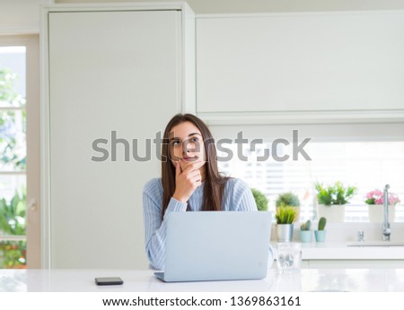 Wide angle picture of beautiful young woman working or studying using laptop serious face thinking about question, very confused idea Royalty-Free Stock Photo #1369863161