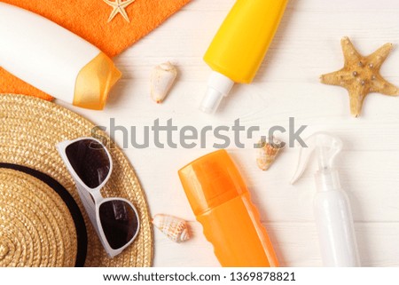 
seashells, beach accessories and sun protection on a colored background top view. Sunscreen