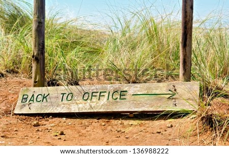 'Back to office' sign board - closeup. Shot in Monk's Cowl nature reserve, Drakensberg Mountains, South Africa.
