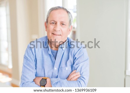 Handsome senior man smiling confident with crossed arms