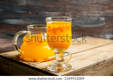 Hot buckthorn beverage in glass. Selective focus. Shallow depth of field. 