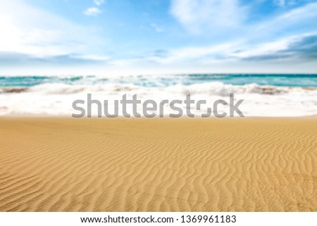Sand background of free space for your decoration. Blurred sea with sky. Summer time. 