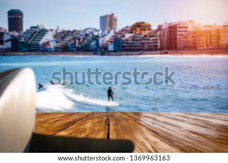 Desk of free space and summer background of sea with surfers and waves. Summer time background. 