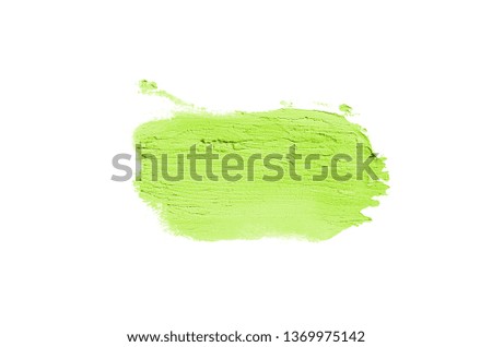 Smear and texture of lipstick or acrylic paint isolated on white background. Stroke of lipgloss or liquid nail polish swatch smudge sample. Element for beauty cosmetic design. Light green color
