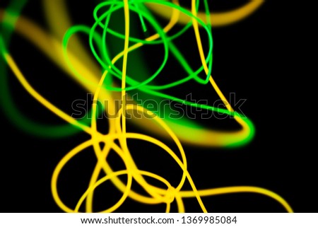 Yellow neon and green neon abstract. Neon lines. Isolated on black background.