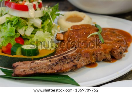 Pork steak and vegetable salad in a plate