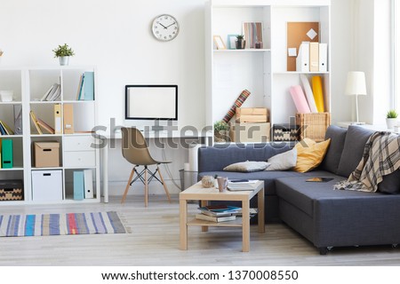 Wide angle shot on domestic interion in white and blue with home workplace in living room, copy space Royalty-Free Stock Photo #1370008550